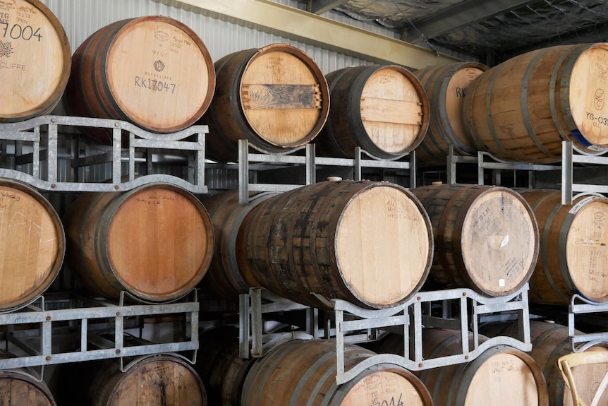 Barrels of whiskey stacked on shelves