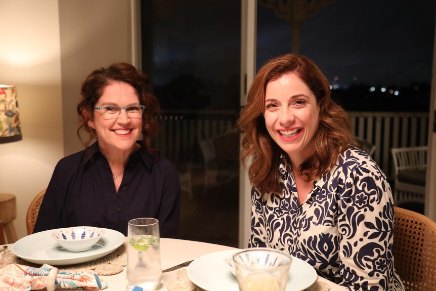 Anika Wells sitting at a dining table with Annabel Crabb after filming Kitchen Cabinet 