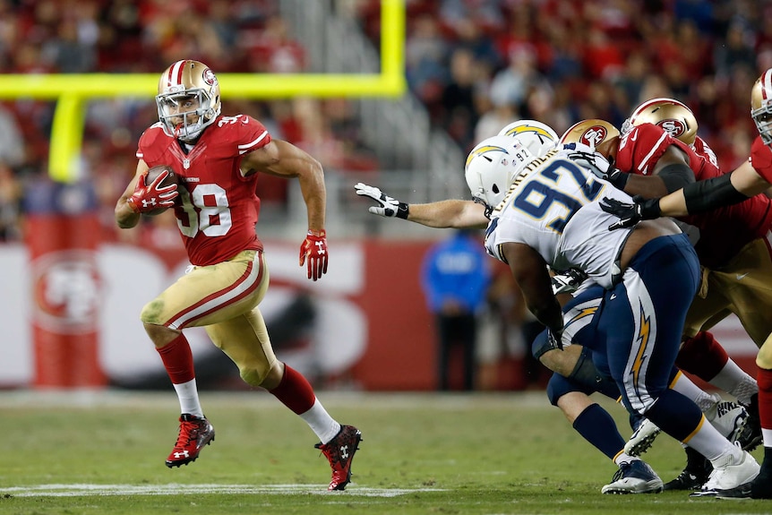 Jarryd Hayne runs the ball for the San Francisco 49ers against the San Diego Chargers in the NFL.