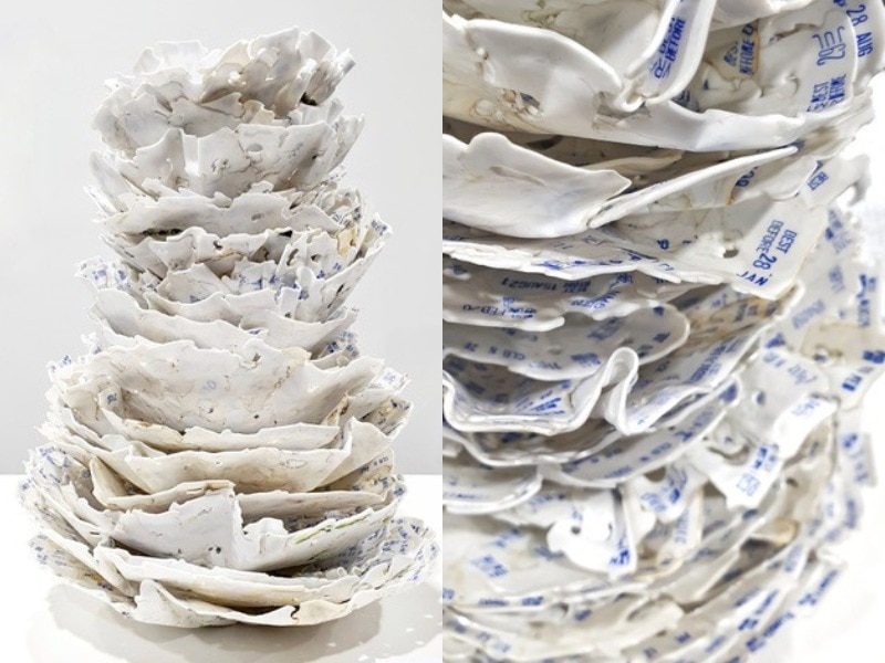 White bread tags have been melted into a towering, stacked plate-like sculpture