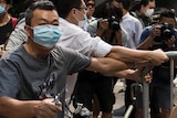 Masked anti-Occupy Central protester cuts cable ties at barricades