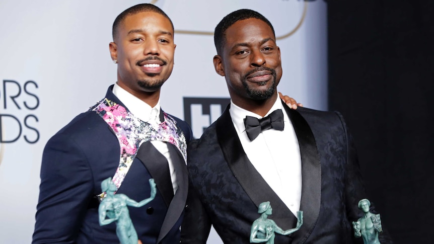 Michael B. Jordan on the red carpet of the Academy Awards wearing a designer harness