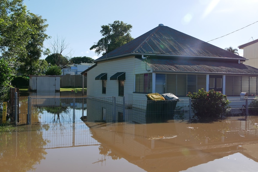 Flood water surrounds a house