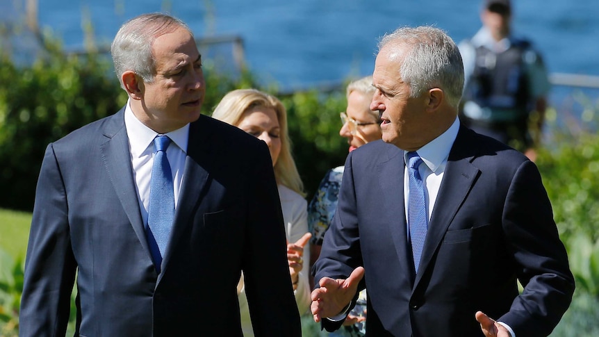 Benjamin Netanyahu and Malcolm Turnbull talk as they walk across the Admiralty House lawn in Sydney.