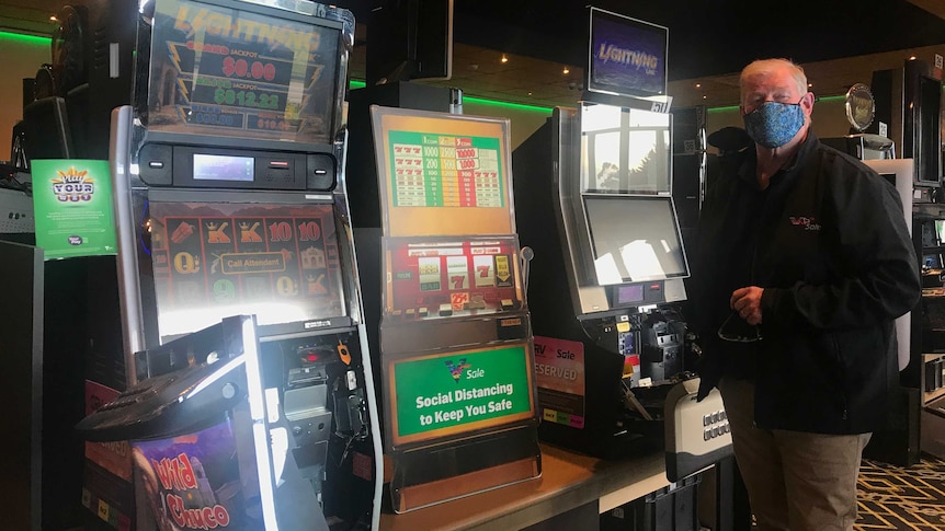 Peter Johnston standing in front of poker machines