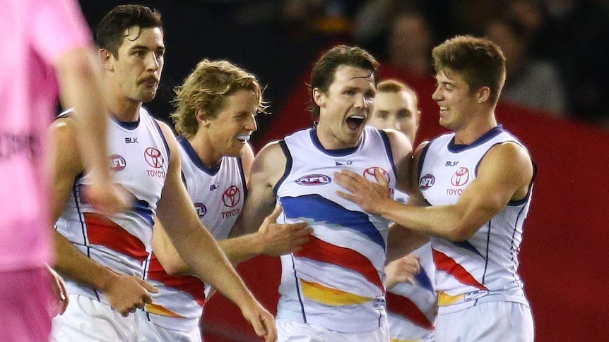 Patrick Dangerfield and team-mates celebrate a goal for the Adelaide Crows