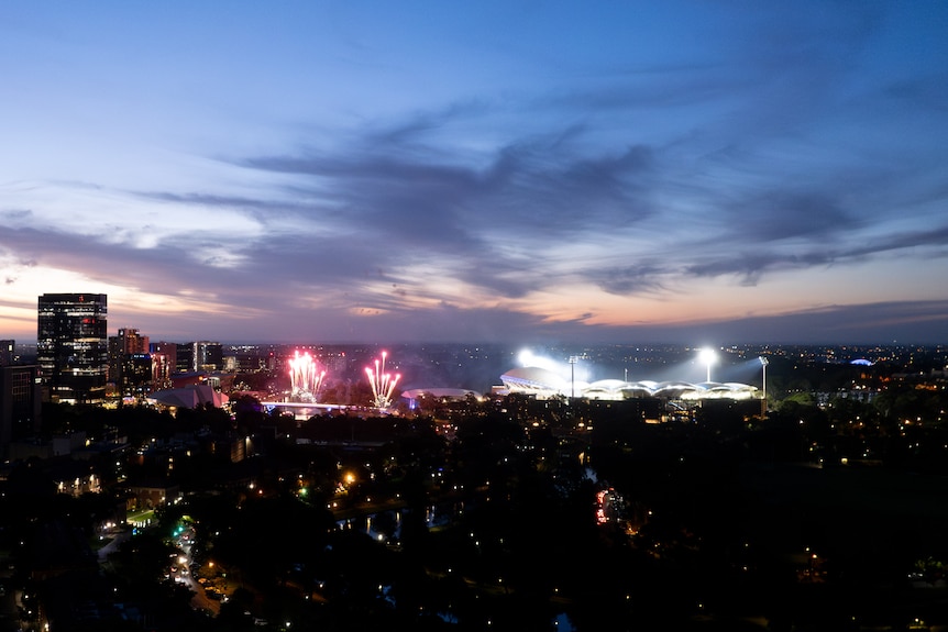 A wide aerial shot of fireworks near the Adelaide CBD at night.