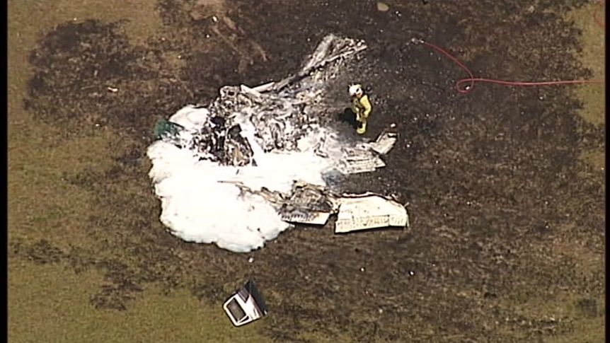 A Cessna 206 skydiving plane reduced to burnt debris on a runway.
