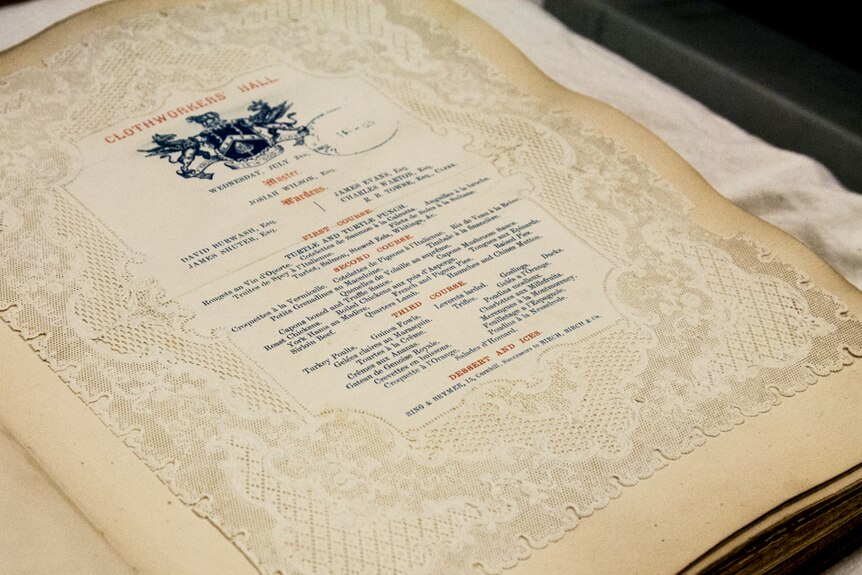 A menu printed on piece of lace-framed cloth.