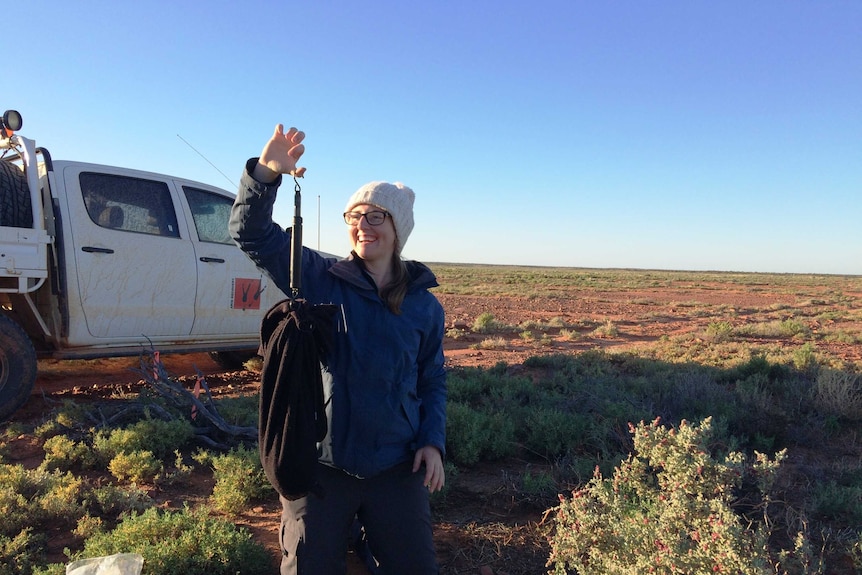 University student Mel Jensen holding up a trapped bandicoot