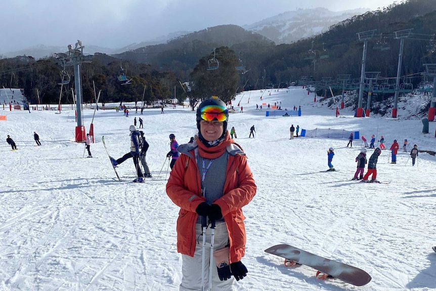 A woman in ski gear at the bottom of a slope in Thredbo