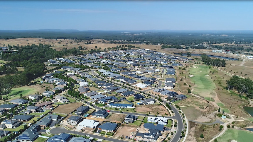 A drone shot of a housing development in a semi-rural area.