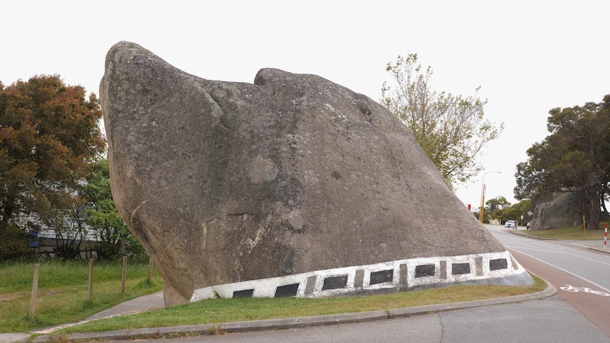 a rock on the side of a road