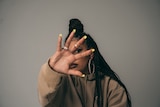 Rapper BARKAA holds her hand up to the camera