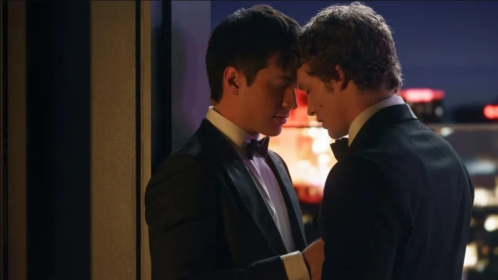 Two men in tuxedos with their foreheads touching.