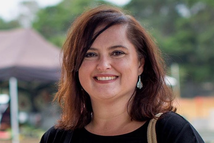 Former Victorian Greens MP Nina Springle smiles at the camera.