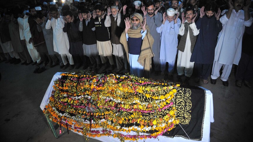 Pakistani relatives and residents offer funeral prayers for the victim of earthquake in Peshawar.