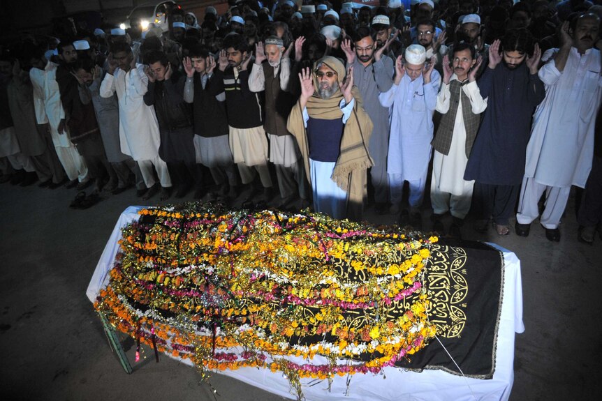 Pakistani relatives and residents offer funeral prayers for the victim of earthquake in Peshawar.