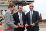 John Gorman from Port Kembla Coal cuts a ribbon with Mark McGowan and Andrew Howie from thyssenkrupp Industrial Solutions.