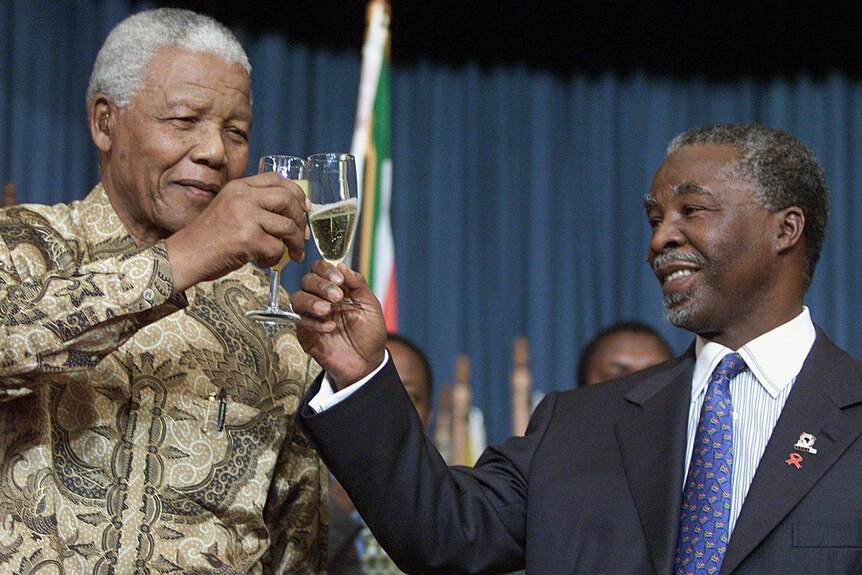 Nelson Mandela and Thabo Mbeki toast to congratulate the Germans for winning the 2006 world cup bid