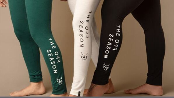 Three pairs of legs wearing branded leggings.