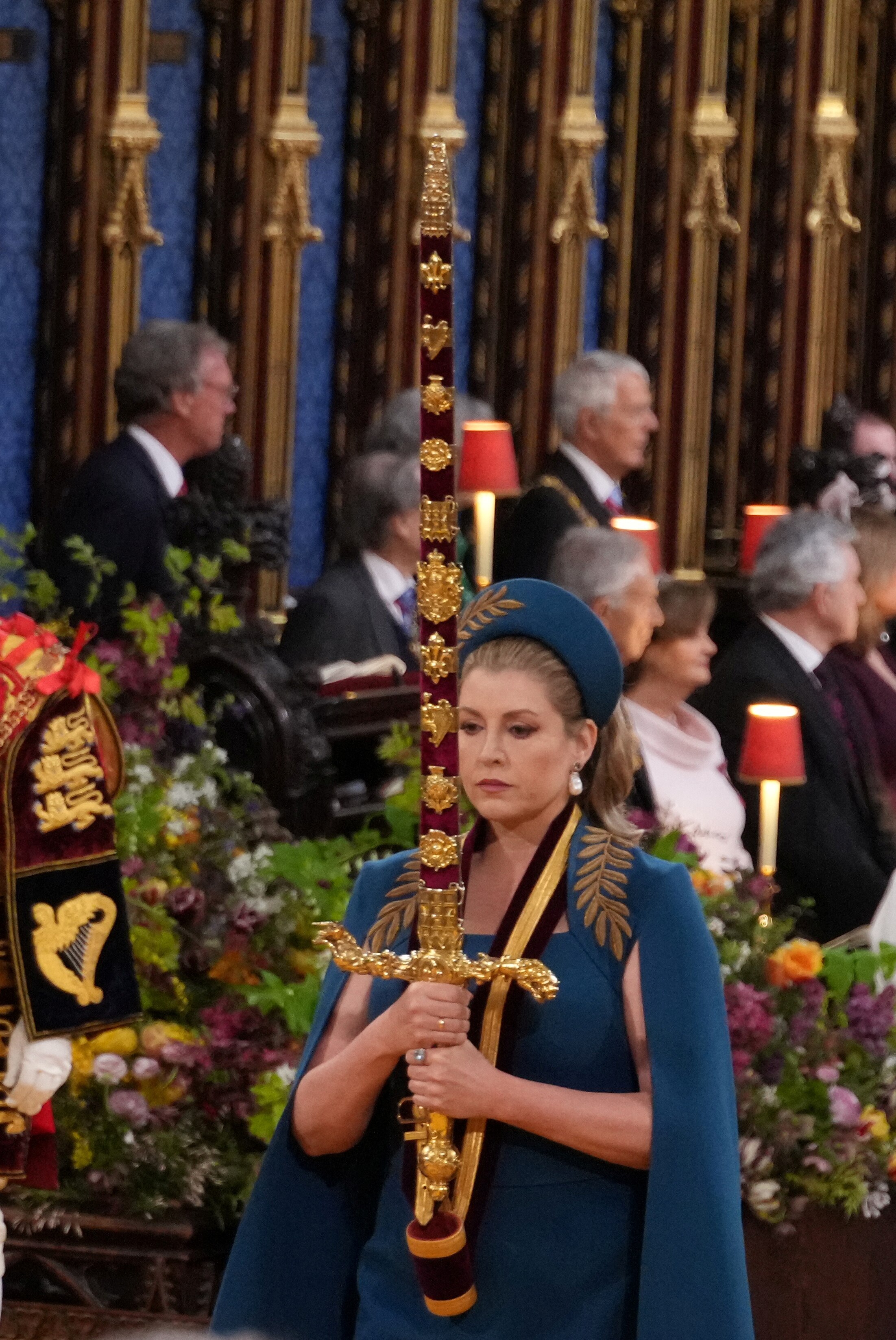 Lord President of the Council, Penny Mordaunt, carrying the Sword of State, in the procession through Westminster Abbey