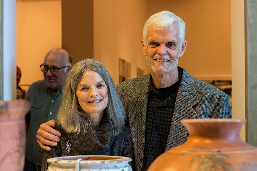 A woman and a man at a pottery exhibition