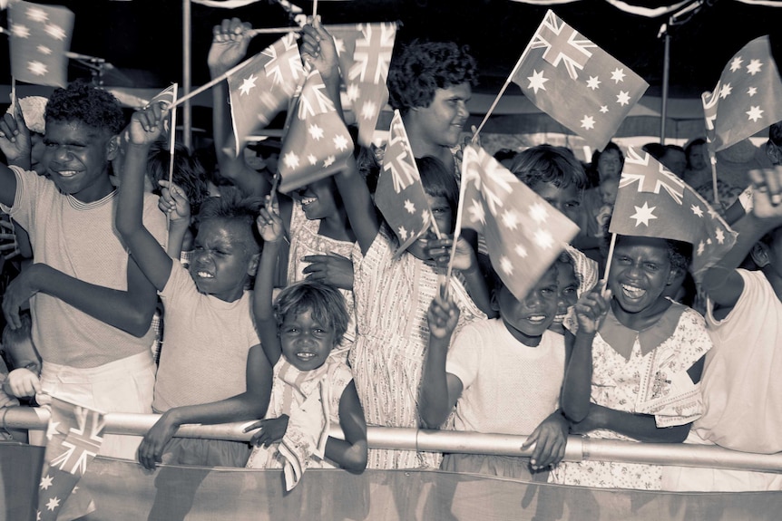 Aboriginal children wait to greet the Queen at the Alice Springs airport in 1963.