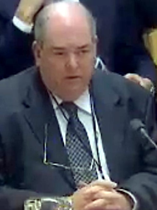 Father Brian Lucas speak at a senate hearing.