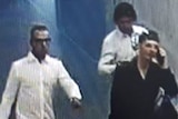 A CCTV screenshot of three men.