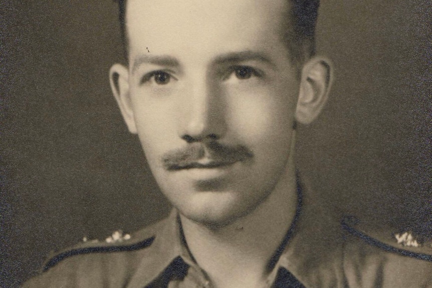 A black and white photo of Tom Moore in his soldiers uniform.