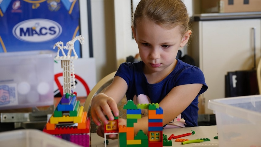 A girl constructing Lego.