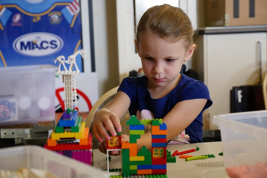 A girl constructing Lego.