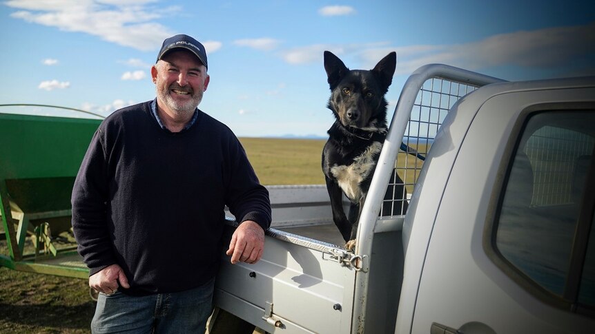 Farmer Stuart Madsen with his dog dusty at his farm outside Little Swanport.