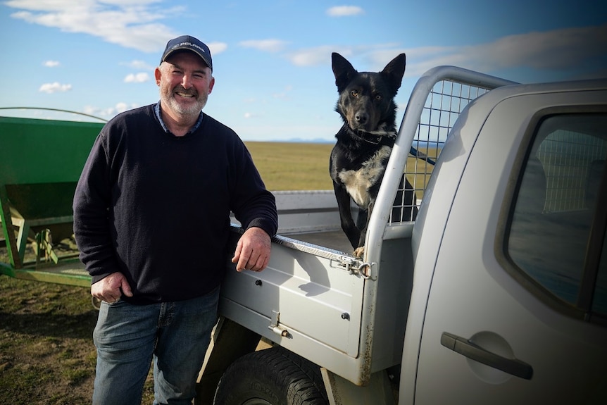 Farmer Stuart Madsen with his dog dusty at his farm outside Little Swanport.