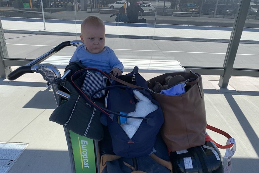 Hudson at the airport with luggage
