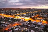 An aerial shot of an outback city at night.