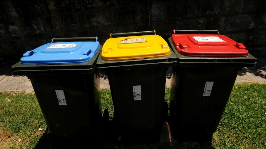 Recycling bins sit with a general waste bin in Sydney