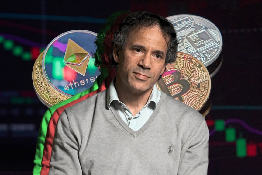 Composite image of a main in a grey sweater with stock charts and cryptocurrency coins behind him.