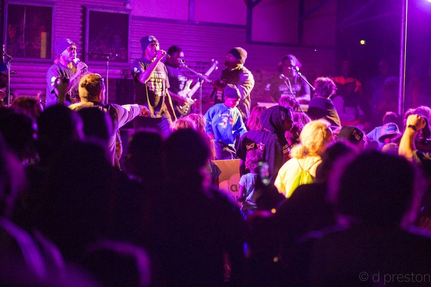 Lonely Boys playing before a crowd at a community show in Wingellina.