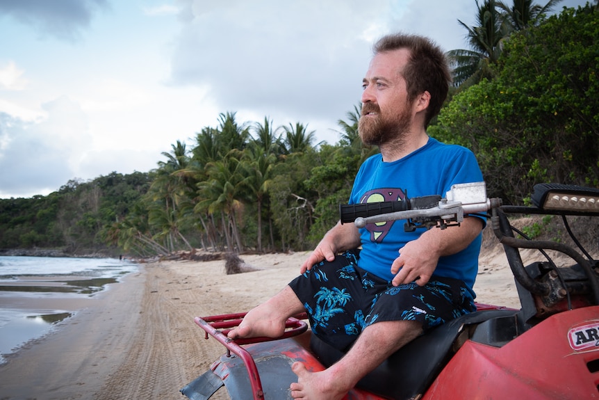 Scooter Patterson sitting on a quad bike on the beach