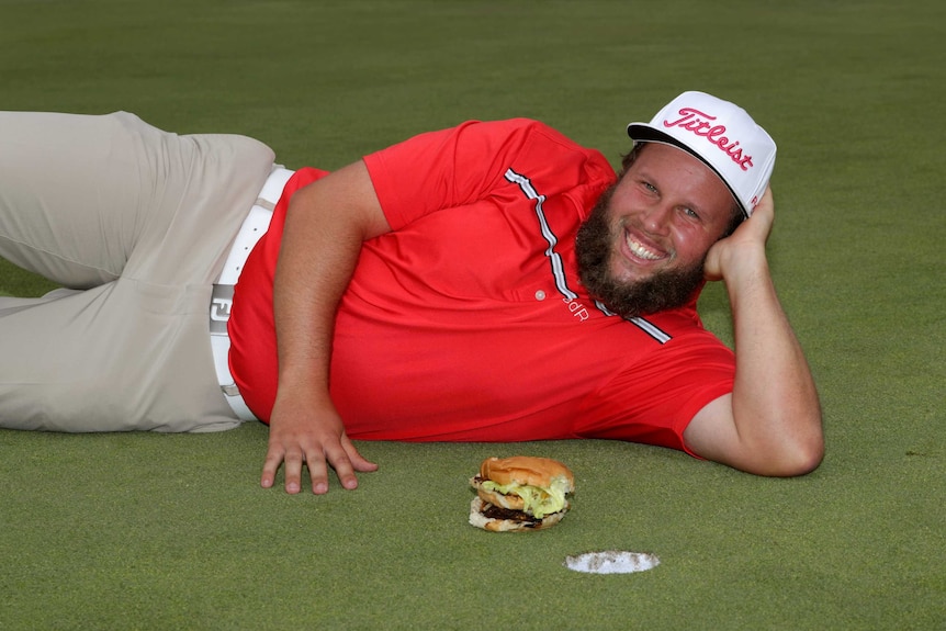 Beef Johnston poses with a hamburger
