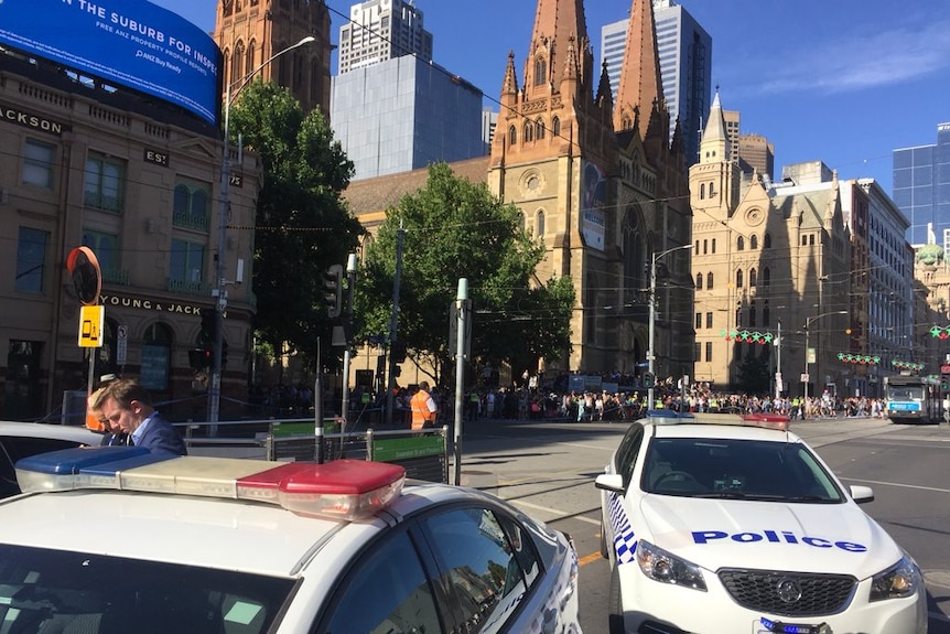 Police cars block off access to Flinders Street Station.