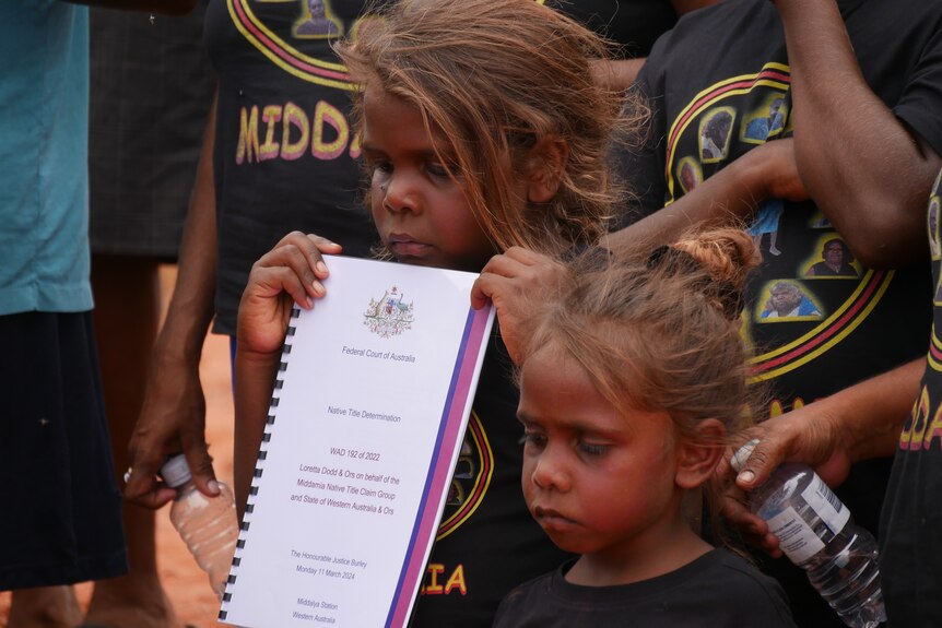 A child holding official paperwork