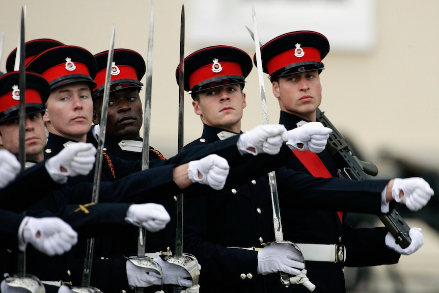 Prince William marches in full military uniform.