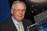 Neil Armstrong stands next to the Ambassador of Exploration Award at the Cincinnati Museum Centre at Union Terminal.