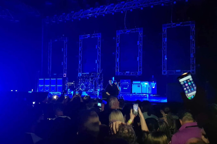 The crowd waits as technicians try to fix a power outage at the Red Hot Chili Peppers in Hobart