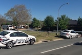 Police cars and tape around a home in Dexion Place in Dunlop.