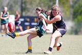 Two girls playing AFL football.