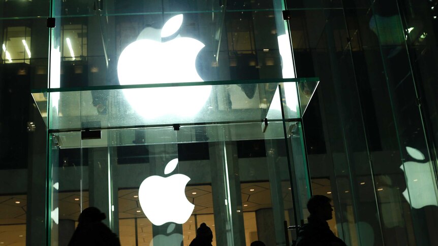 People walk outside the Apple store.